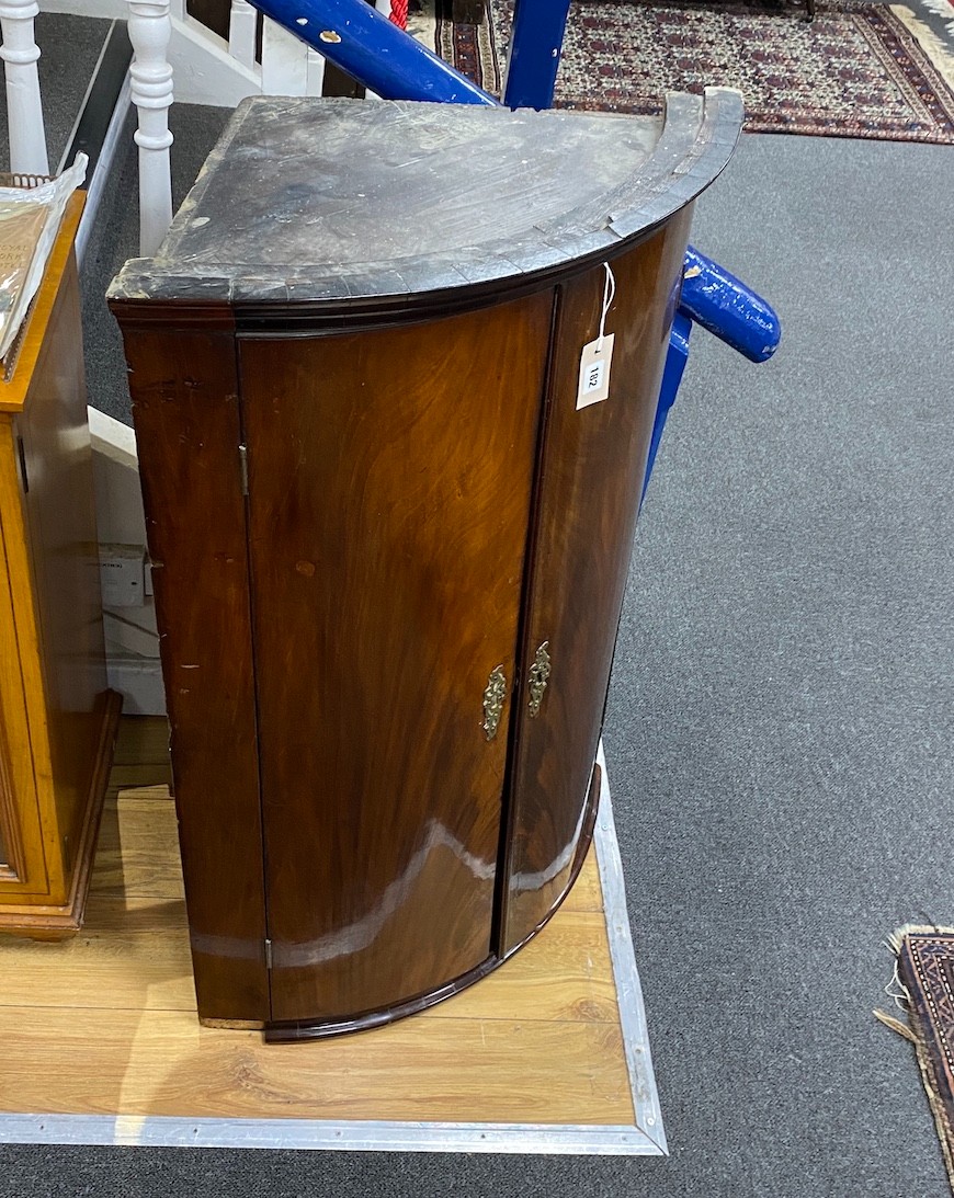 A George III mahogany bow front hanging corner cabinet, width 72cm, depth 50cm, height 102cm